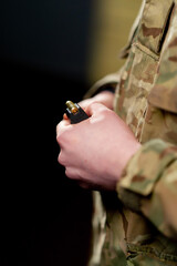 close-up at a professional shooting range military trainer loads a magazine with bullets