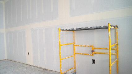 Newly installed drywall with scaffolding 
