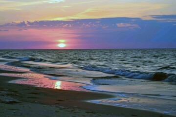 Sunset painting the sky with hues of orange, pink, and purple, signaling the end of summer day
