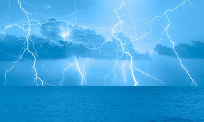 Beautiful landscape with lightning over the calm sea 