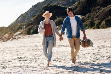 Couple, love and holding hands on beach for vacation, summer and walking for anniversary in nature....