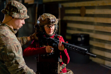 In a professional shooting range young girl in tactical ammunition is preparing to shoot