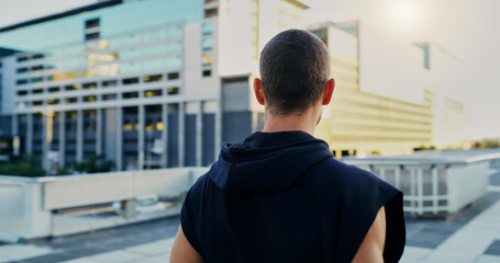 Back, fitness and man thinking in city for running, cardio workout or endurance training. Lens...