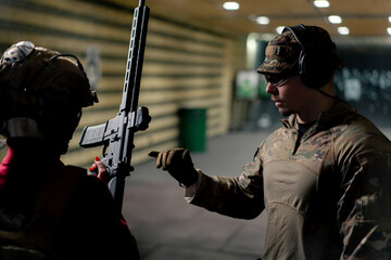 At a professional shooting range military trainer teaches a cheap girl how to hold a NATO rifle...