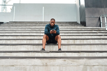 African man, smartphone and sports, stairs and stadium for training, outdoor or workout on stands...