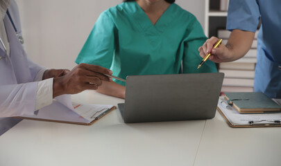 Medical Team Meeting Around Table In Modern Hospital