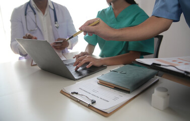 Medical Team Meeting Around Table In Modern Hospital