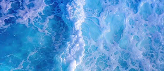 Obraz premium Ocean waves texture with blue ripples and white foam. Summer tropical travel panorama , turquoise blue and white surf surface for copy space by Vita for web or mobile