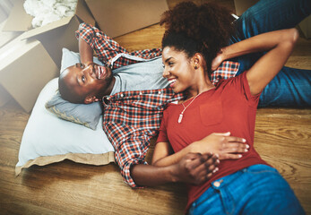Relax, moving and happy couple on floor in new home with boxes, talking and mortgage with high...