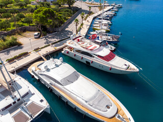 Scenic aerial view many yachts boats moored at Croatian bay harbor shore blue turquoise clear water...