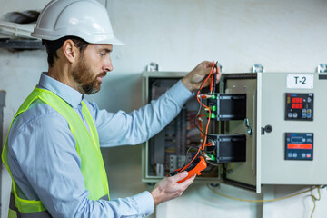 Electrician at work hold voltmeter