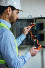 Electricity maintenance service, Electrician hand holding measuring meter checking current voltage
