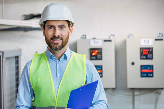 male occupational technical worker or health and safety officer inside factory doing inspection