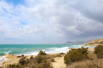 Obraz premium beach and sea, cloudy sky over sea and rocks,sea waves breaking against the rocks 