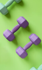 small fitness dumbbells colorful background, gym and bodybuilding pattern