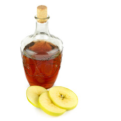Apple vinegar in glass bottle and ripe apples isolated on white. There is free space for text.