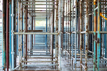 Exposed scaffolding under the ceiling for pouring concrete at a construction site.