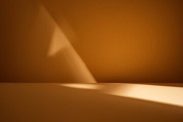 Empty table with natural light reflection and shadow on light brown wall. Background for products,...