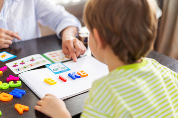 Child Learning Letters with Colorful Magnets