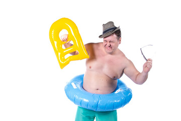 Vacations and holidays. Funny fat man with an inflatable blue circle posing in the studio on a white background. Fun and joy.
