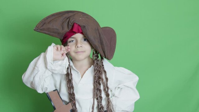 Thumb up, Adorable kid in pirate costume disagree with something. isolated on green, slow motion with copy space. High quality 4k footage