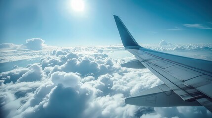 Obraz premium This aerial view showcases an airplane wing against the backdrop of a bright blue sky punctuated by fluffy white clouds, signifying travel and freedom