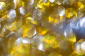 Gold light shiny bokeh abstract blurred background with bright hexagons defocus golden pattern, can...
