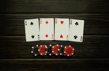 Successful win with four playing cards in club. Poker game with four of a kind or quads combination...