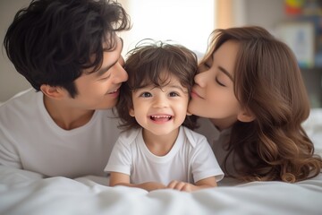 happy child with parents playing in the bed at home