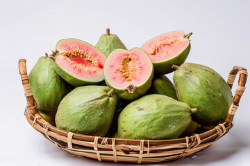 A selection of fresh, ripe guava, their green skins and pink interiors vibrant and inviting, arranged in a wicker basket against a white background.