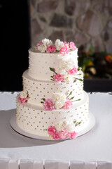 wedding cake adorned with pearls and flowers