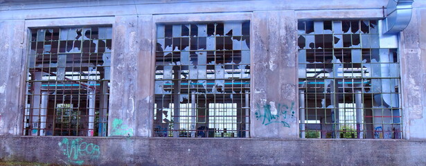 Old broken windows of the abandoned factory in Austria.