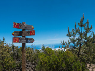 Tourist Signpost at hiking trail PR1.2 to Achada do Teixeira and PR1.1 to Ilha and PR1.3 to Encumeada. Madeira , Portugal. Blue sky, copy space