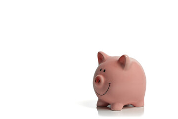 Smiling, pink piggy bank isolated on a white background; concept image ceramic piggy bank...
