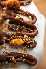 Chocolate Drizzle and Nuts Topping on White Frosting