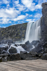 Oxararfoss, spectacular Icelandic waterfall. Þingvellir National Park. Cold water falls on large...