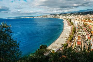 Fantastic Promenade des Anglais,  people swimming in Mediterranean Sea and sunbathing on beach    -...