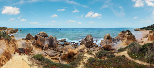 Summer Atlantic rocky coast panorama (Albufeira outskirts, Algarve, Portugal). Panorama.