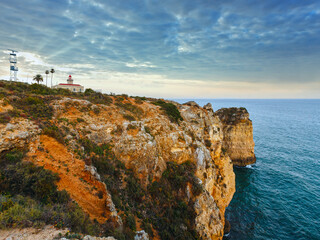 Evening view of lighthouse on cliff (Ponta da Piedade headland, Lagos, Algarve, Portugal).