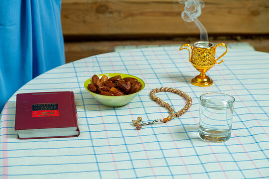 Smoldering bakhur and rosary on the table before the start of fasting
