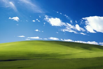 Fototapeta premium A beautiful summer or spring landscape with green grass on the hills and green fields. The blue sky is filled with white clouds and bright sunlight. Nature as a background.
