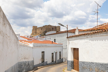 a street in Segura de Leon with a view to the castle,  comarca of Tentudia, province of Badajoz, Extremadura, Spain