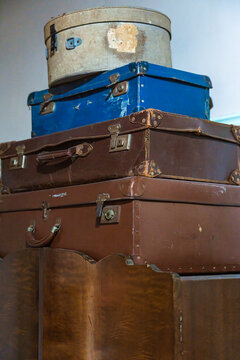 Vintage suitcases stacked in rustic setting