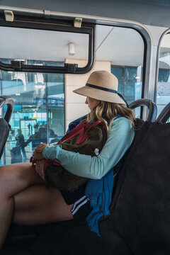 Pensive woman looking out of airport shuttle window