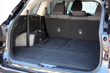 Modern wagon car open trunk. Car boot is open. Clean, open empty trunk in the black car SUV. 