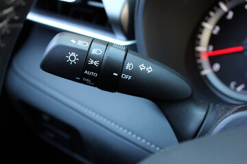 Close up of light control in car. Car light switch. Car interior with light switch. The light knob in the car. Multifunction Headlight Console Control Switch knob.