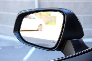 Rear view mirror car on the road. Rearview mirror with reflection in it. Accessory for vehicles to look back on road for good visibility and drive car safely.