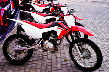 Fototapeta premium red and white racing motorcycles in the parking lot in the park,