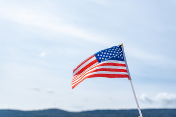 American flag waving against a clear blue sky