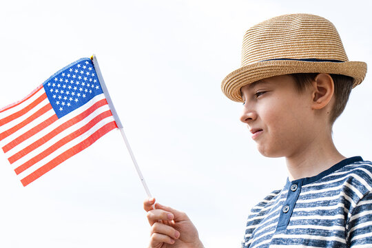 Young Boy Holding American Flag for Independence Day - Powered by Adobe